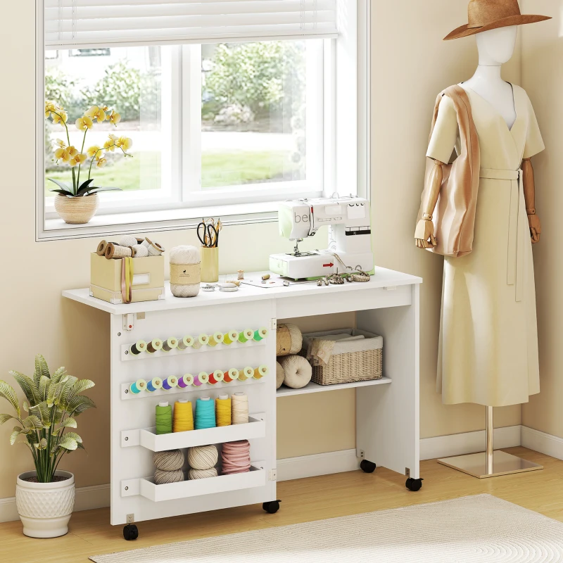 HOMCOM Sewing Machine Table on Wheels, Folding Craft Table with 2 Bins, Storage Shelf, 18 Pegs, Lockable Wheels, White