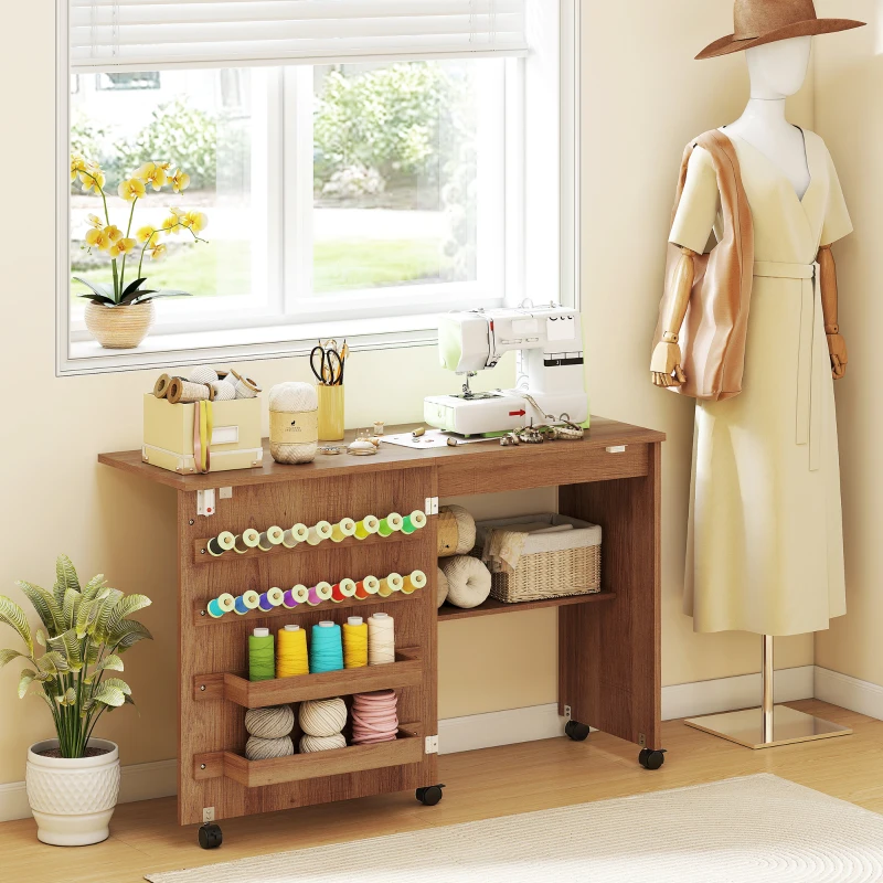 HOMCOM Sewing Machine Table on Wheels, Folding Craft Table with 2 Bins, Storage Shelf, 18 Pegs, Lockable Wheels, Brown