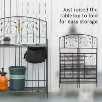 Outsunny Folding Potting Bench Table, Metal Garden Workstation, Work Bench with Large Built-in Bag with Cover, 5 Hanging Hooks & Storage Shelf, Leaf Pattern(m-5)